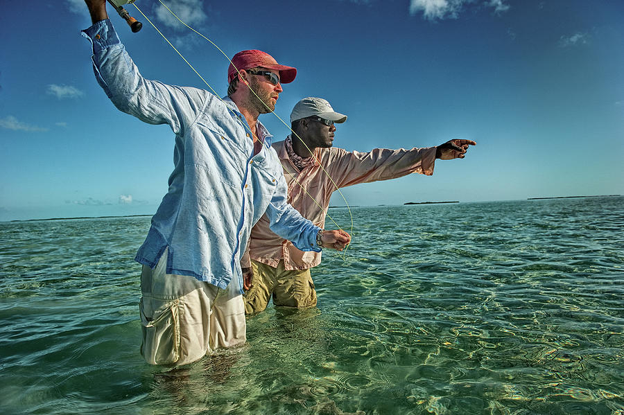 Fisherman with Bone Fishing Guide in Exuma, Bahamas by Newton Powell