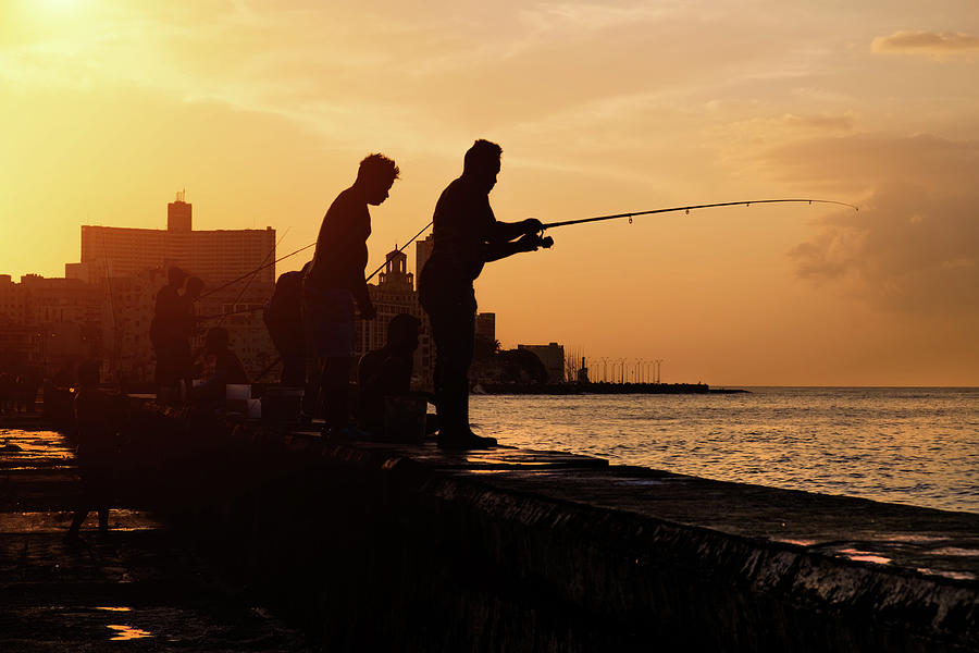 Fishermen at sunset in Havana Photograph by Karel Miragaya
