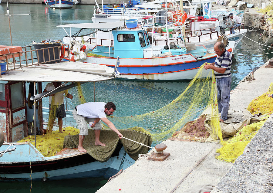 Fishermen repairing nets Heraklion Crete Photograph by Bryan Attewell