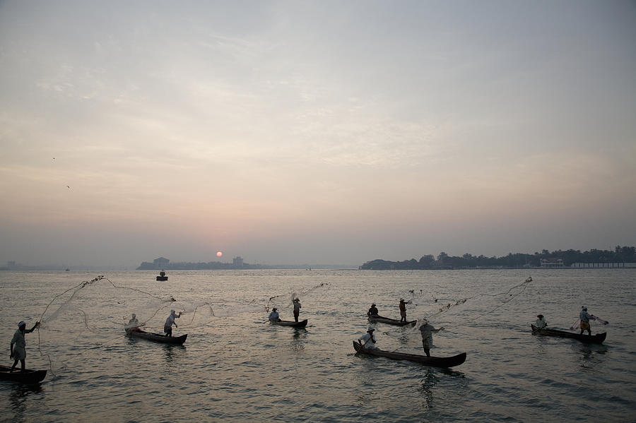 Fishermen throwing fishing nets in Cochin, India Photograph by John Lund
