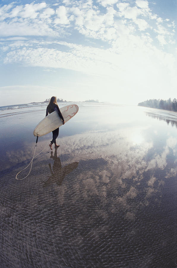 Fisheye Lens Shot of a Man Carrying a Surfboard on an Isolated Beach Photograph by Darryl Leniuk