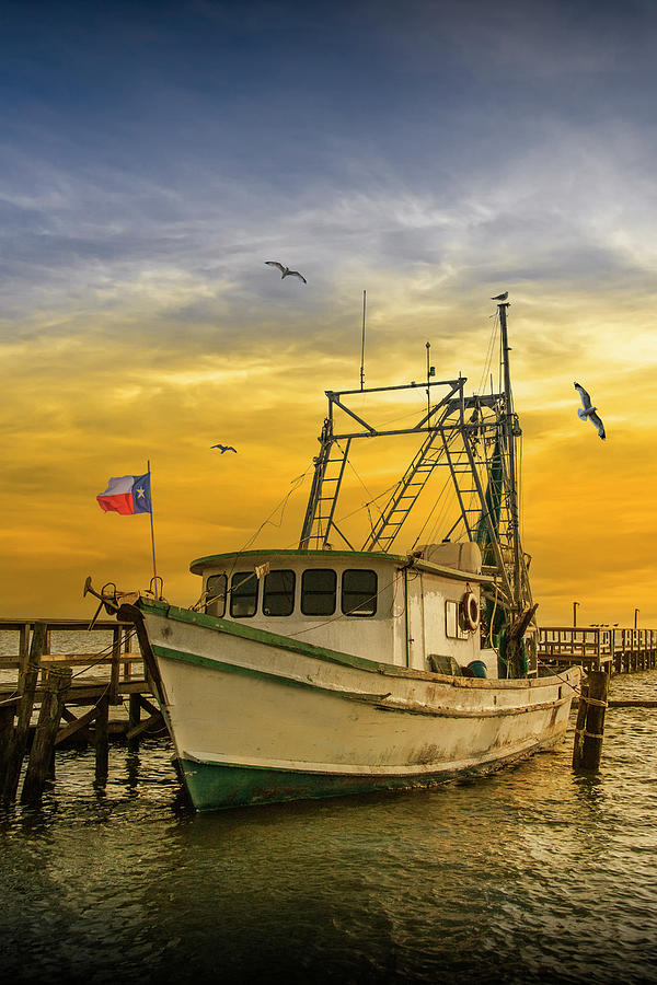 Fishing Boat at Sunrise flying the Texas Flag in the harbor at A Photograph by Randall Nyhof