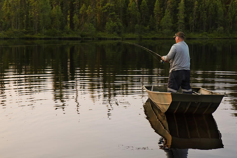 Fishing Boat In Lake Water Near Forest In Summer With Fisherman With Rod by  Ashley Swanson