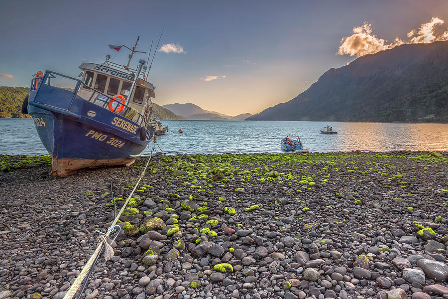 Fishing boat moored in the Hornopiren fjord at golden hour Photograph by Henri Leduc