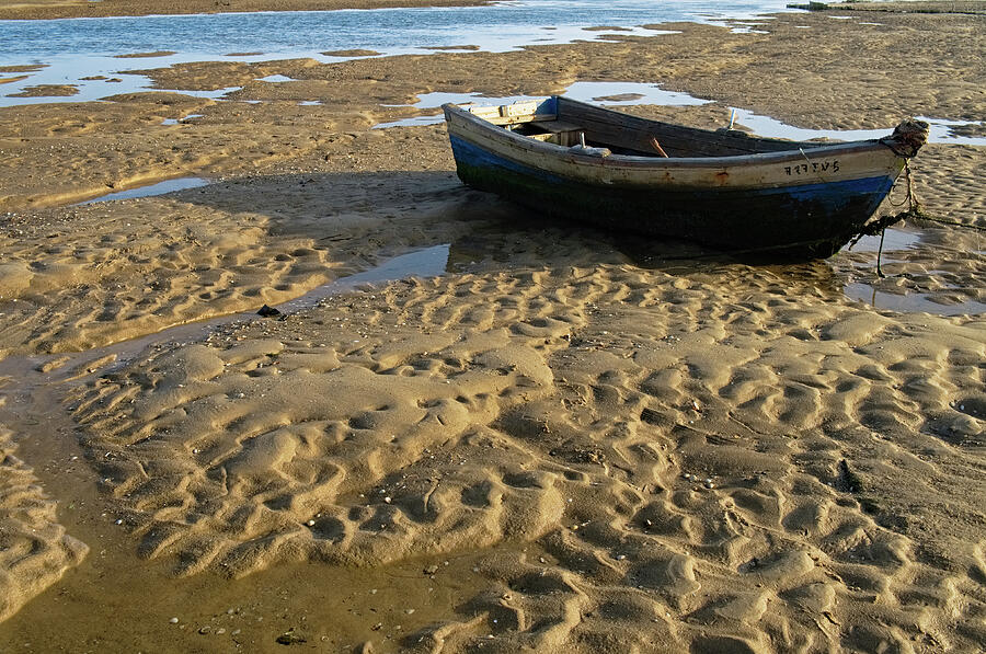 Summer Photograph - Fishing boat resting on the beach sand by Angelo DeVal