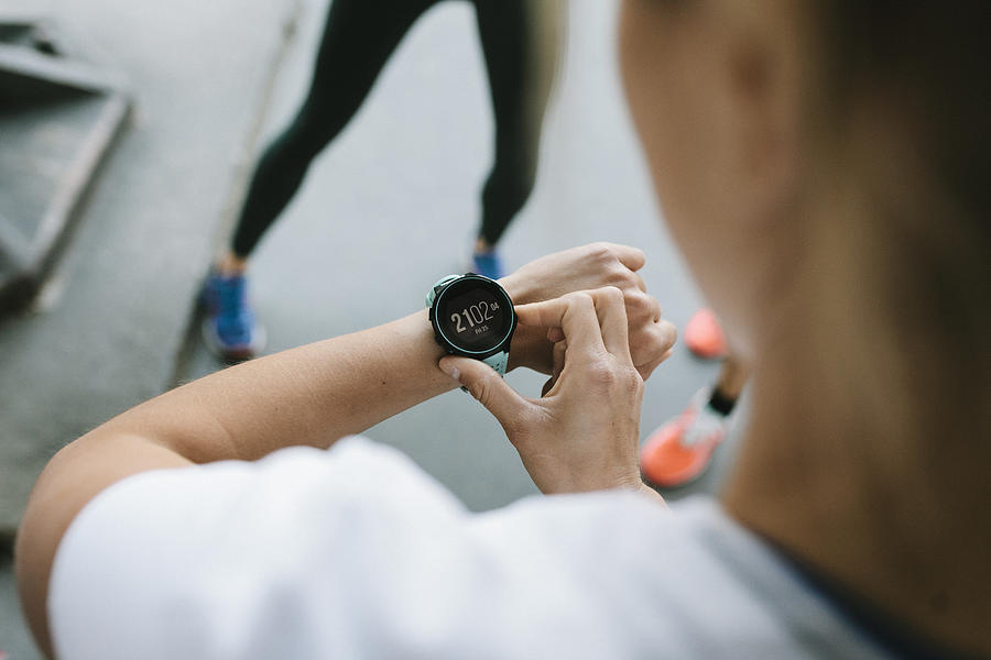 Fitness Enthusiast Setting Timer On Her Watch Photograph by Hinterhaus Productions