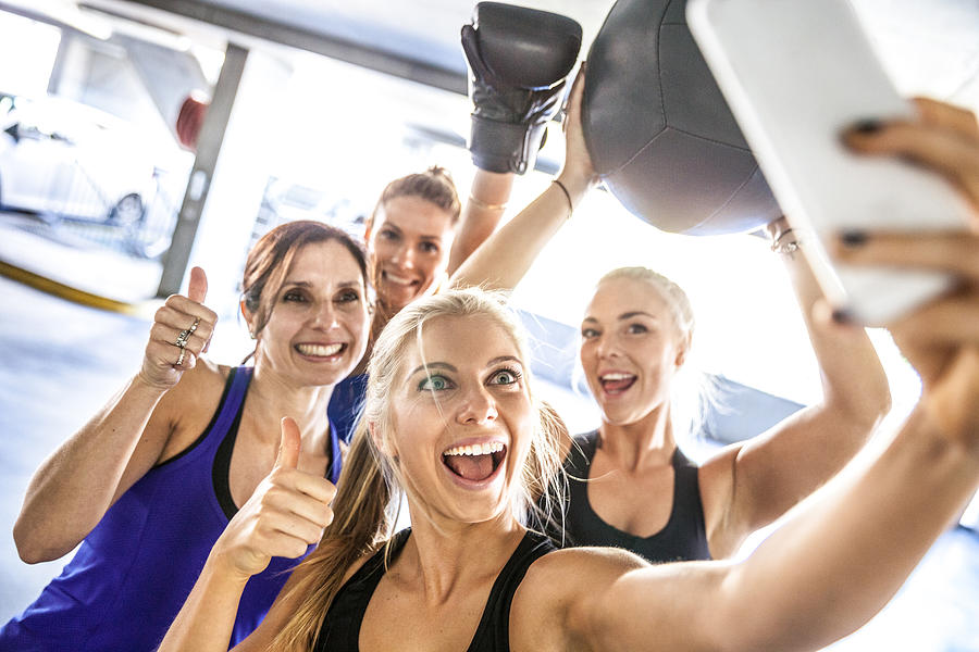 Fitness friends having a break with selfie post workout Photograph by LeoPatrizi