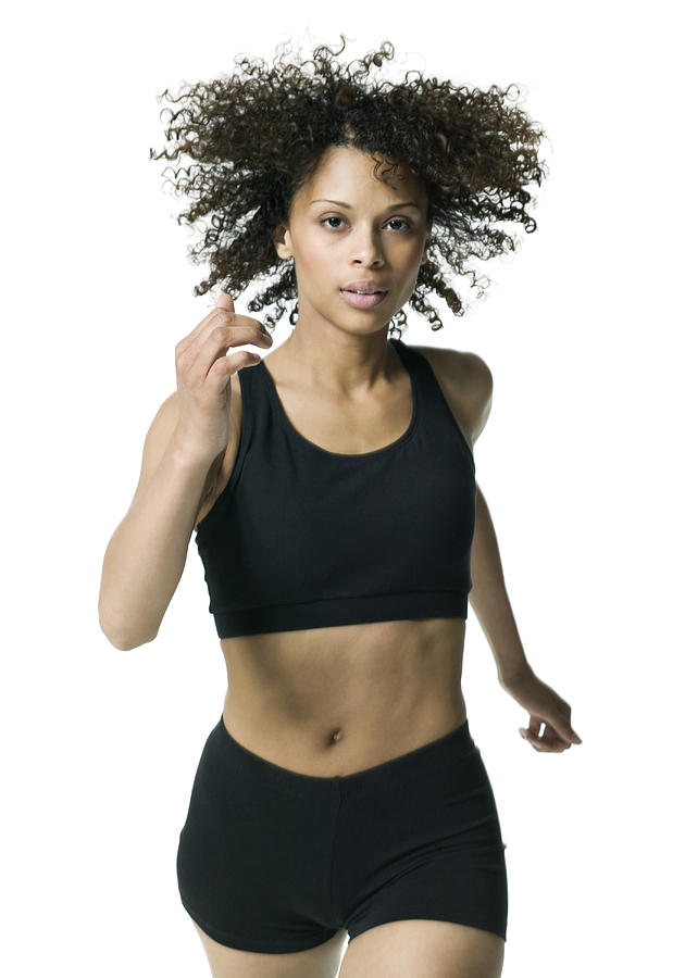 Fitness Portrait Of A Young Adult Female In A Black Workout Outfit As She Jogs Photograph by Photodisc