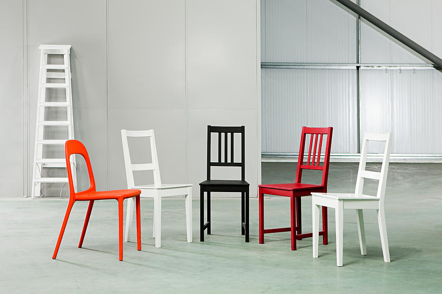 Five chairs in a warehouse Photograph by Image Source