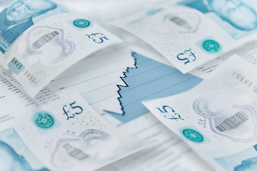 Five pound notes on finance graph Photograph by Caia Image