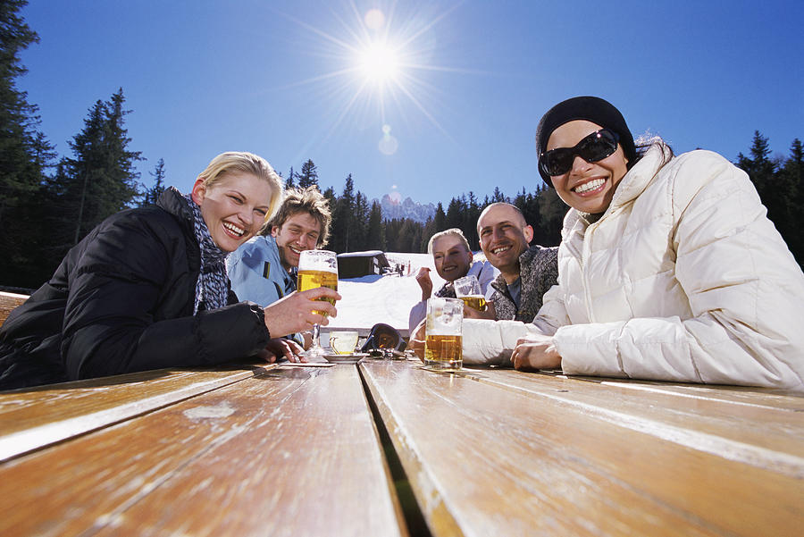 Five Smiling Friends at a Table With Lager in the Snowy Mountains Photograph by Michelangelo Gratton