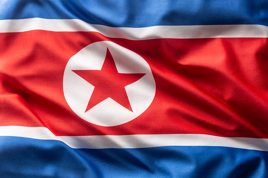 Flag of North Korea blowing in the wind. Photograph by SimpleImages