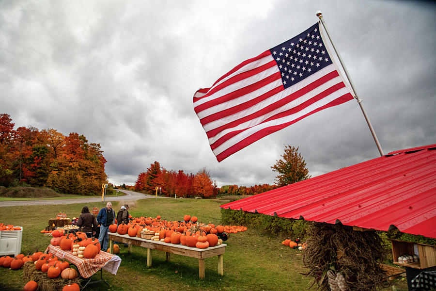 Flag over pumpkins with fall colors in northern Michigan Photograph by Eldon McGraw