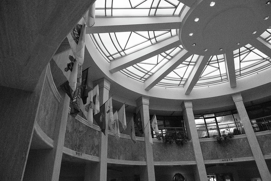 Flags hanging inside New Mexico state capitol building in black and white Photograph by Eldon McGraw
