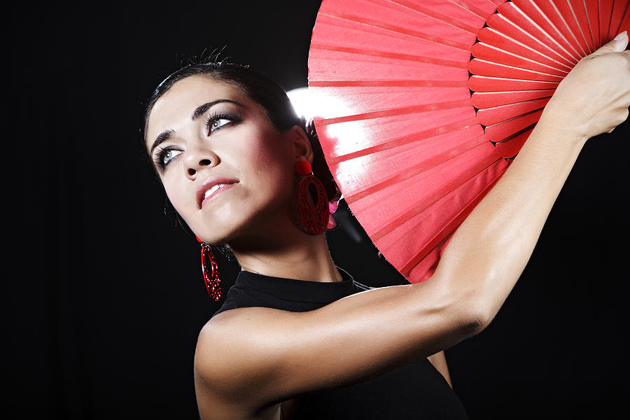 Flamenco dancer with red hand fan looking into the distance Photograph by Kparis