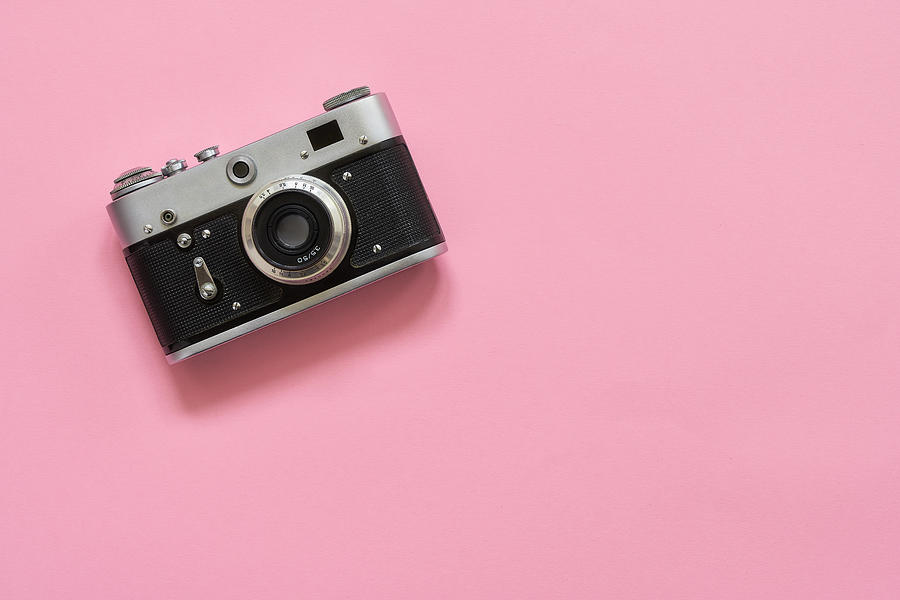 Flatlay vintage retro camera on pink background. Copy space, top view Photograph by Laimdota