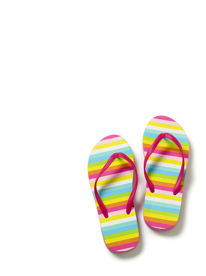 Flip flops on white background. Photograph by Peter Dazeley