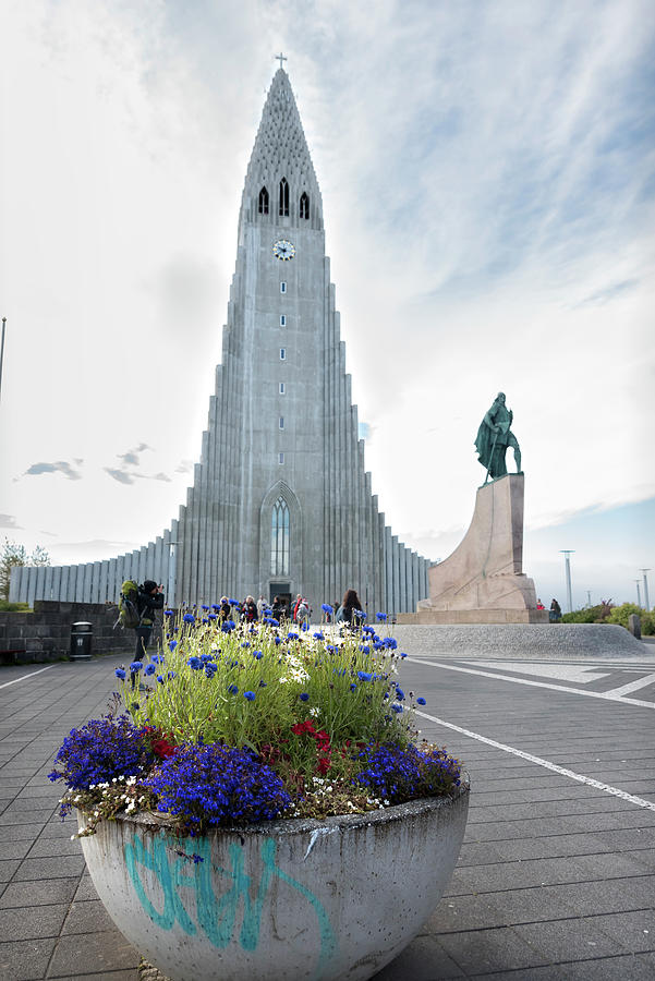 Flower pot, statue of explorer Leif Erikson and Hallgrimskirkja in Reykjavik Photograph by RicardMN Photography