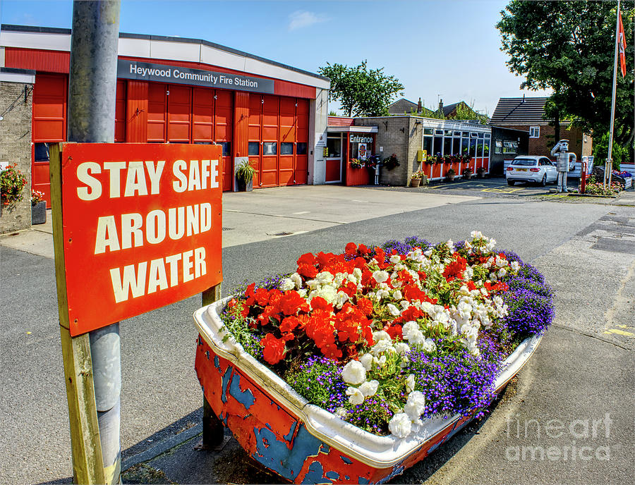Flowers in a boat, Heywood Fire Station, Manchester, UK Photograph by Pics By Tony