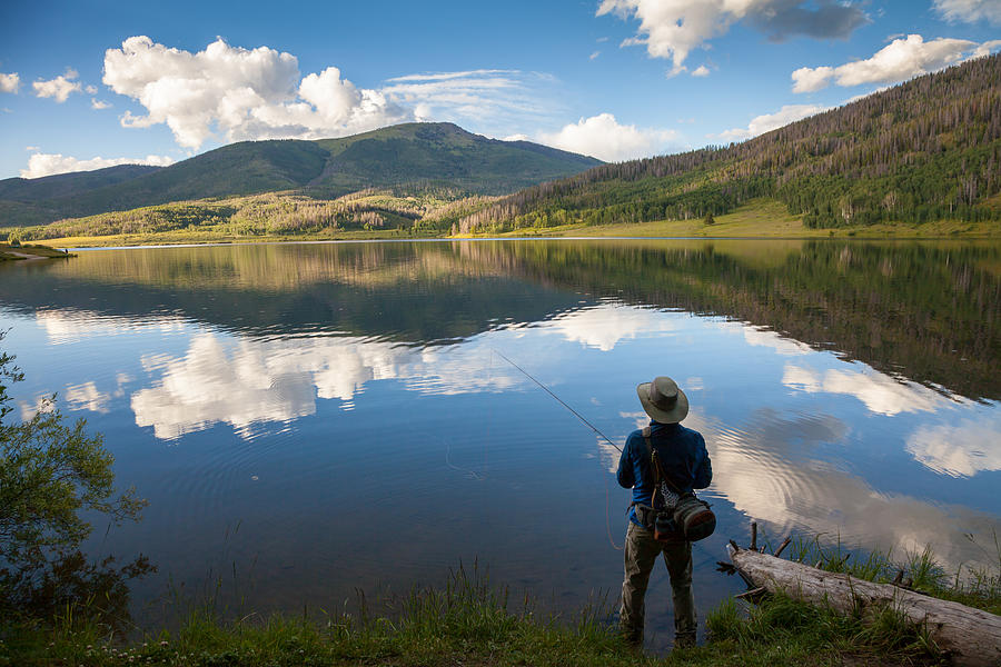 Fly Fisherman At Mountain Lake With Reflections Photograph by Karen Desjardin