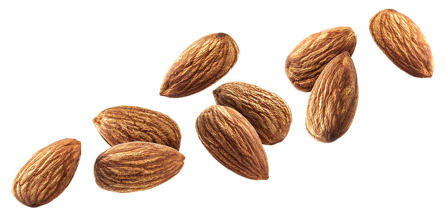 Flying almond isolated on white background with clipping path Photograph by Xamtiw