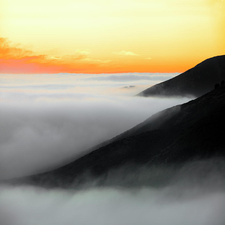 Fog hugging coast at sunset Photograph by Donald Kinney
