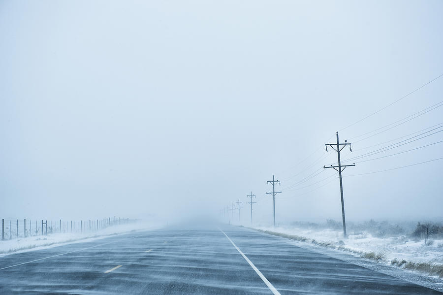 Fog rolling over snowy rural road Photograph by Jacobs Stock Photography Ltd