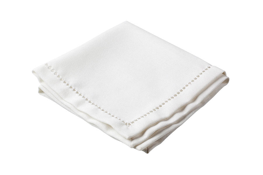 Folded white napkin with embroidered border Photograph by Milanfoto