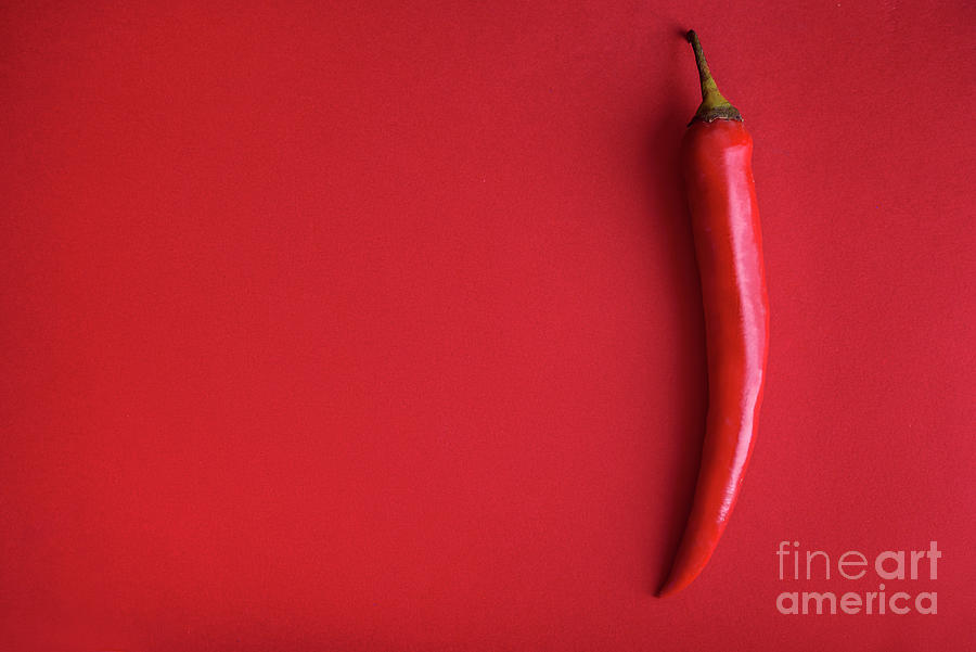 Food background flat lay. Red hot chili pepper on red background Photograph by Jelena Jovanovic