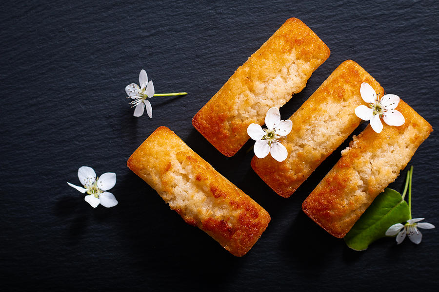 Food concept mini French almond cake financier on black slate stone with copy space Photograph by Buddyb76