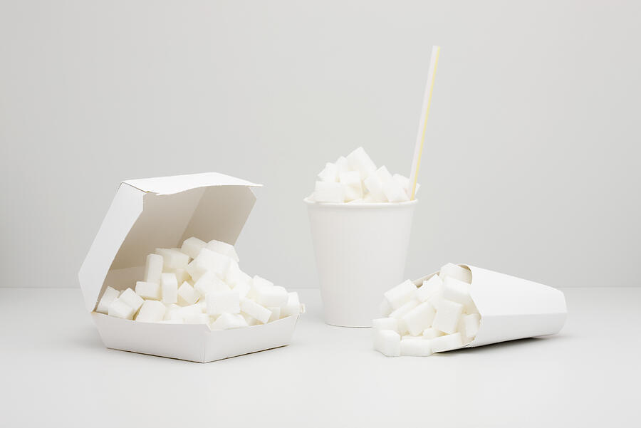 Food concept, sugar cubes inside fast food containers Photograph by PhotoAlto/Milena Boniek