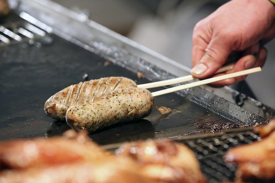 Food stall cooking sausage at Omotesando on New Years Eve Photograph by DigiPub