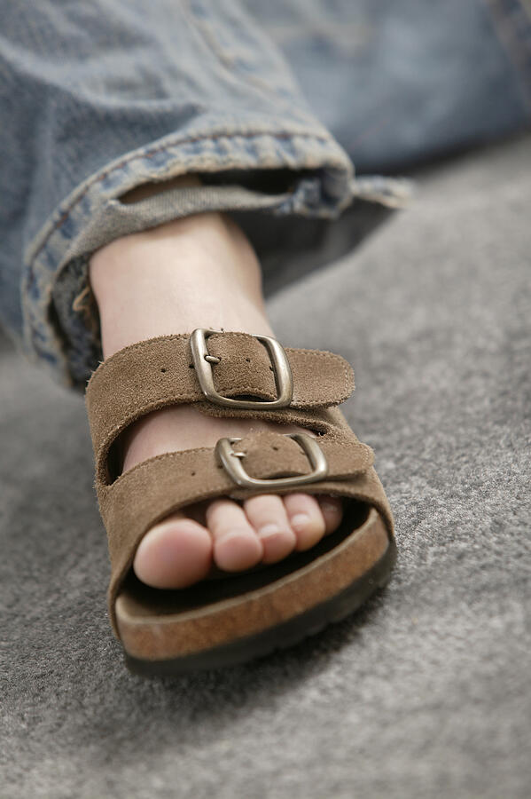 Foot of person wearing sandal Photograph by Comstock Images