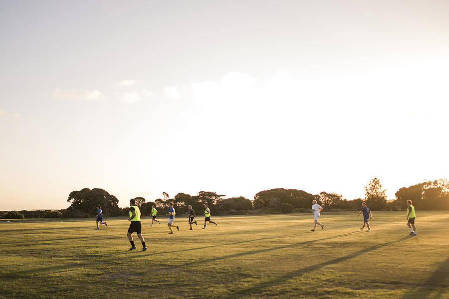 Football at Dusk Photograph by SolStock