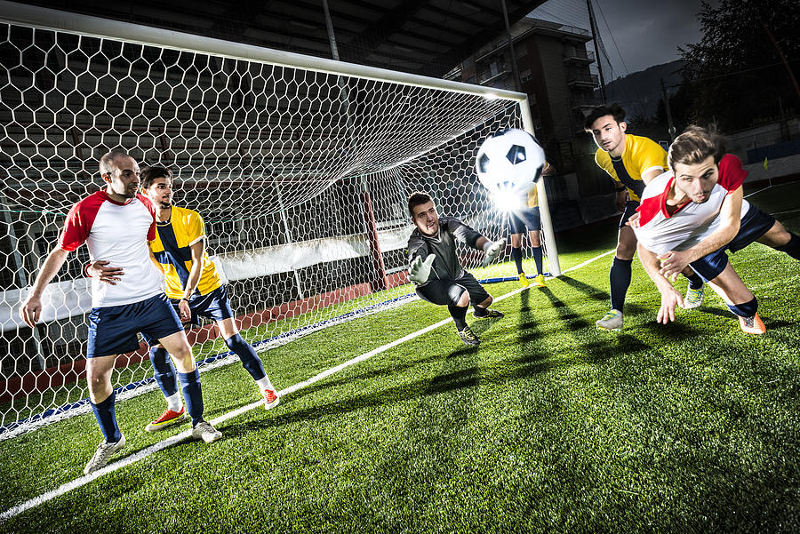 Football match in stadium: Header goal Photograph by Ilbusca