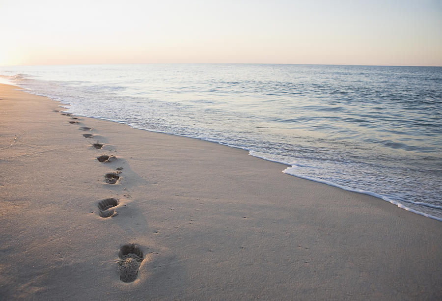 Footprints in the sand Photograph by Tetra Images - Chris Hackett