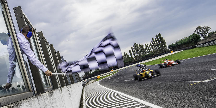 Formula race cars speeding towards the finish line Photograph by Vm