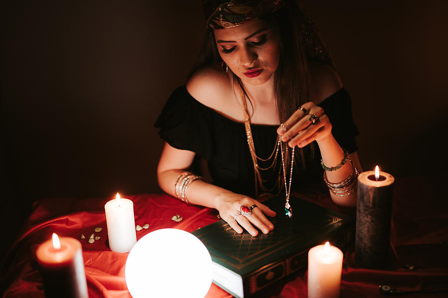 Fortune teller and book of charms Photograph by Urbazon