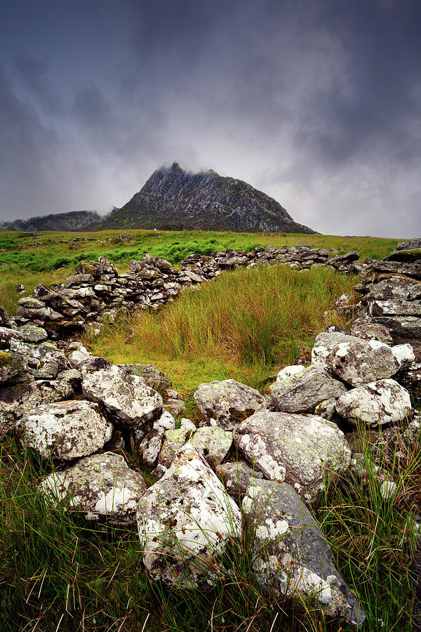 Foundation of stone dwelling with Tryfan in the distance Photograph by Victoria Ashman
