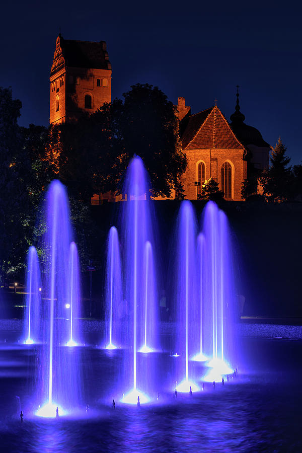 Fountain And Gothic Church at Night Photograph by Artur Bogacki
