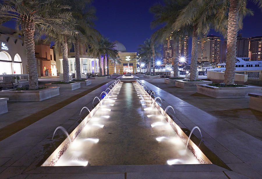 Fountain at night in Pearl marina in Doha Photograph by Allan Baxter