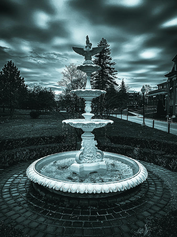 Fountain under a cloudy sky Photograph by Jim Feldman