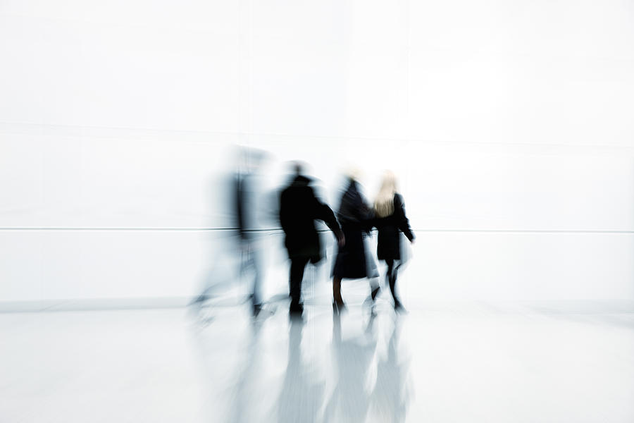 Four Businesspeople Walking in White Corridor, Blurred Motion Photograph by Bim