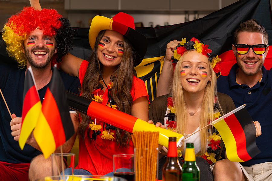 Four Happy German Soccer Fans At Home Photograph by Amriphoto