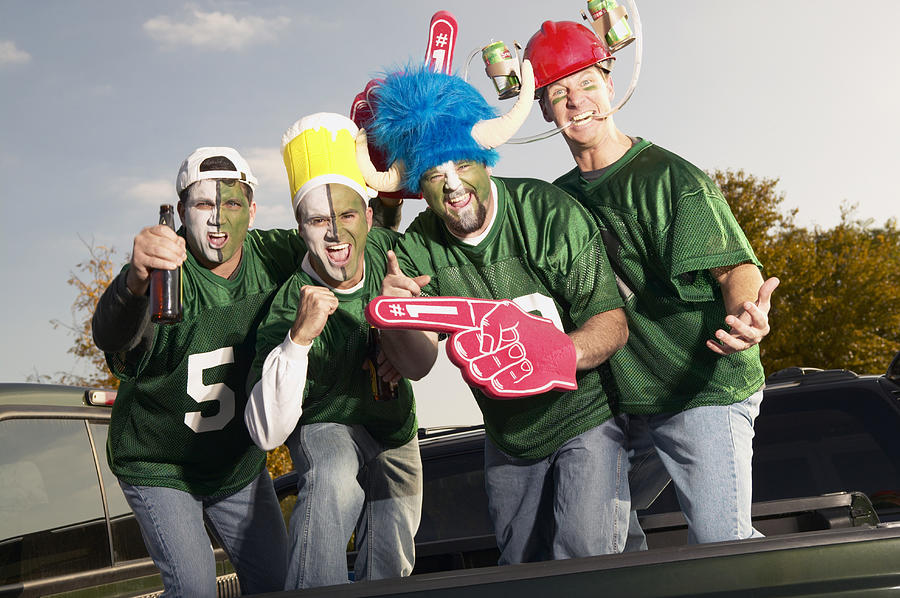 Four male football fans wearing face paint, gesticulating Photograph by Glg3