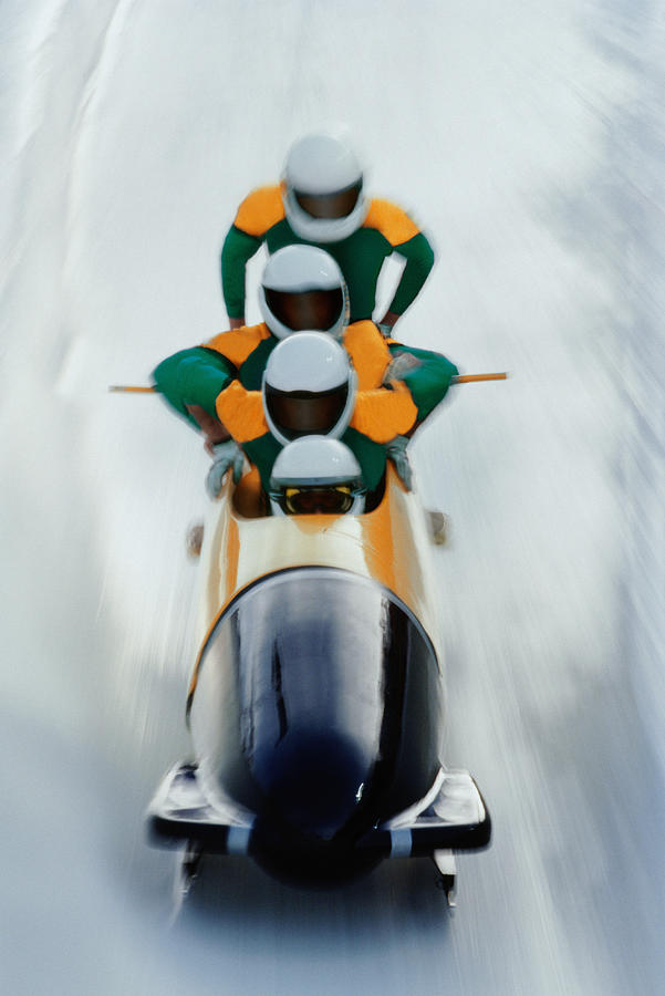 Four man bobsled team mounting their sled (blurred motion) Photograph by David Madison