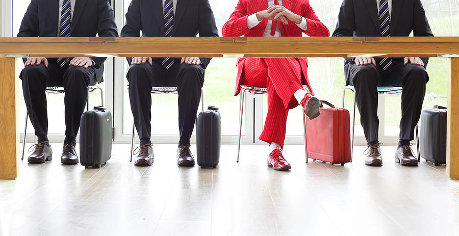 Four men sat at table, one in red suit Photograph by Peter Cade