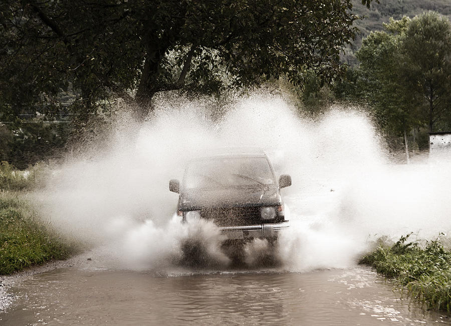 Four wheel drive in puddle Photograph by Buena Vista Images