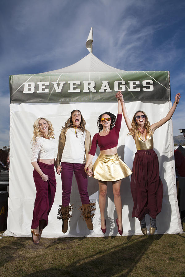 Four Young Woman Jumping At Tailgate Party Photograph by Jason Todd