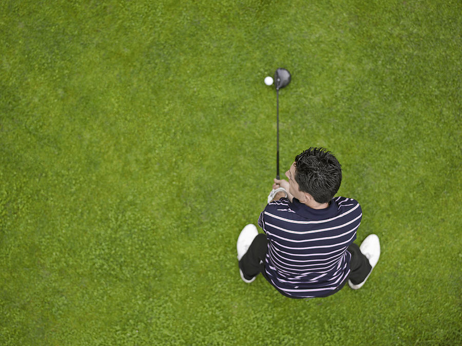 France, Dordogne, male golfer teeing off, directly above Photograph by Photo and Co